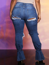 Vaqueros acampanados con cortes y cintura alta de mezclilla